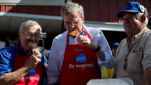Bush eats pork in an apron